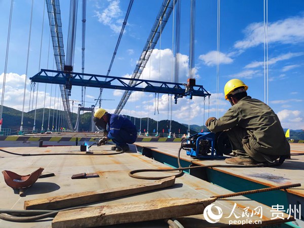工人作大橋合龍前最后準備工作。人民網 李麗萍攝