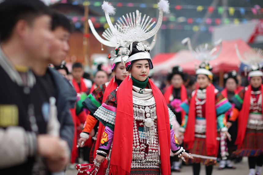2月19日，身著節日盛裝的苗族群眾在“望會節”上跳傳統蘆笙舞。        