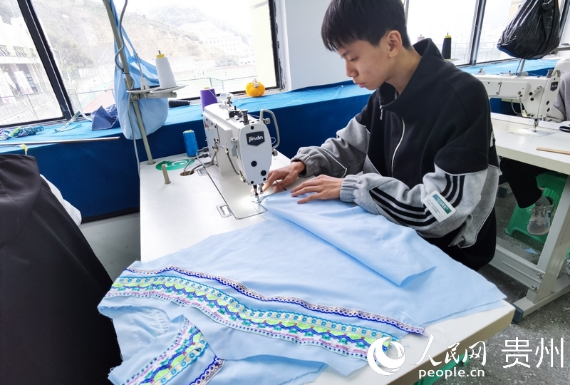 民族服飾實操教室內，學生正在做衣服。人民網 王秀芳攝