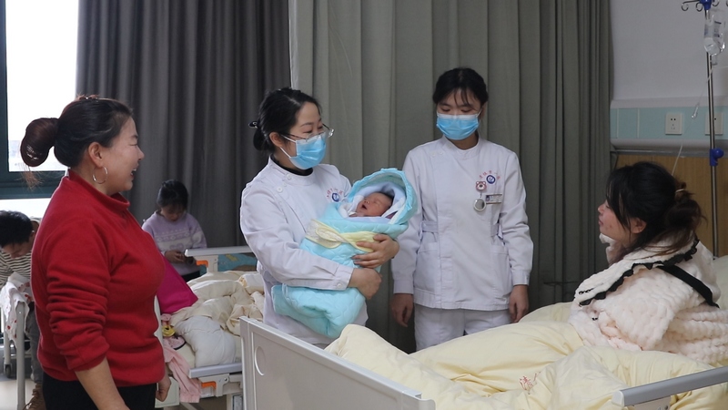 產科護士長鄒艷到病房看望孕產婦和嬰兒。劉曉麗 攝