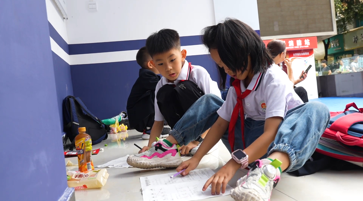 孩子們在派出所門前討論作業