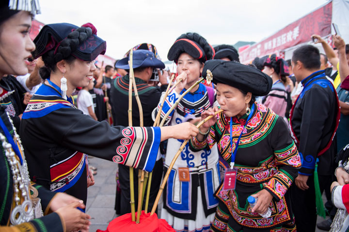 彝家咂酒敬賓客。李學友攝