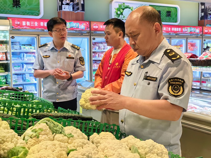 石阡縣市場監管局工作人員在開展食品檢查。