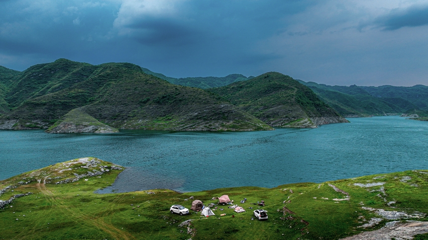 2025年6月14日，游客在在黔西市五里鄉桐山村境內的支嘎阿魯湖畔休閑觀光。