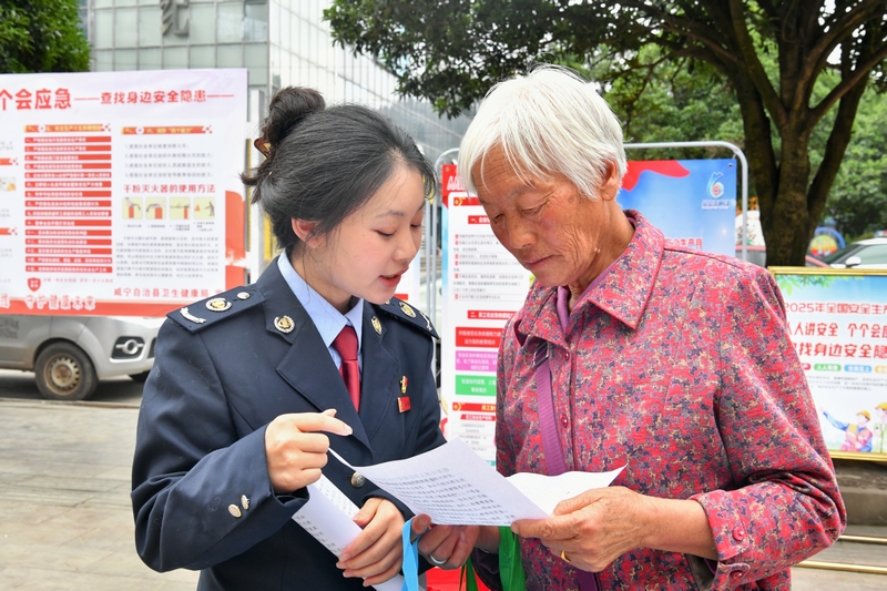 稅務人員向過往群眾宣傳非法集資的危害。張瑜顯攝