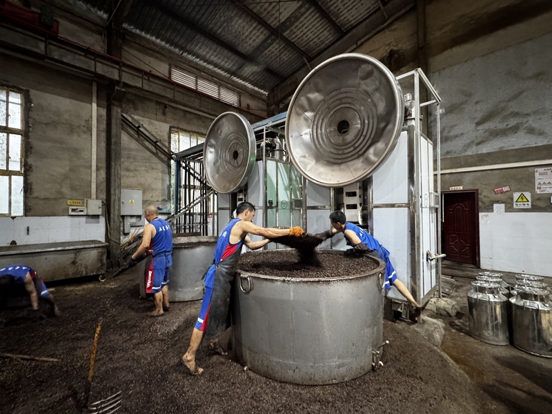 工人用新的熱泵設備釀酒。