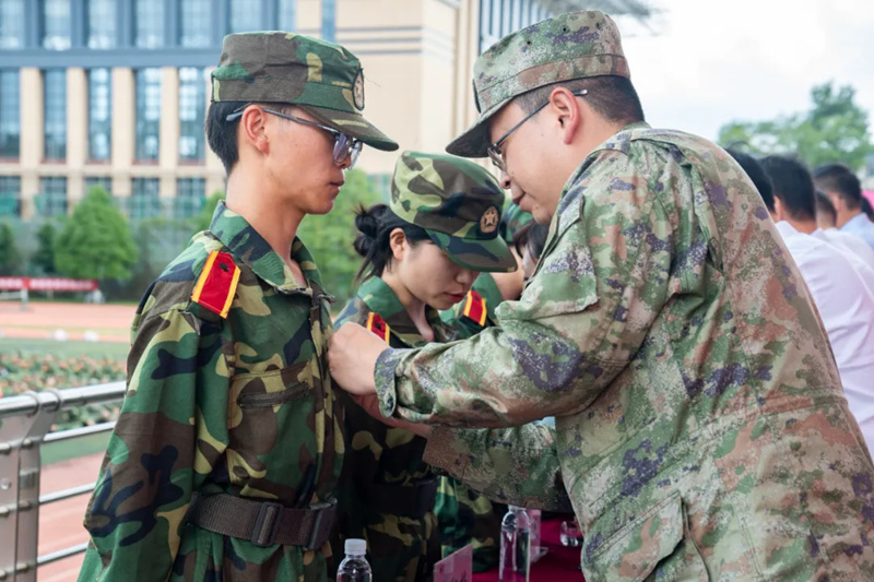 與會領導為新生代表佩戴?；?。