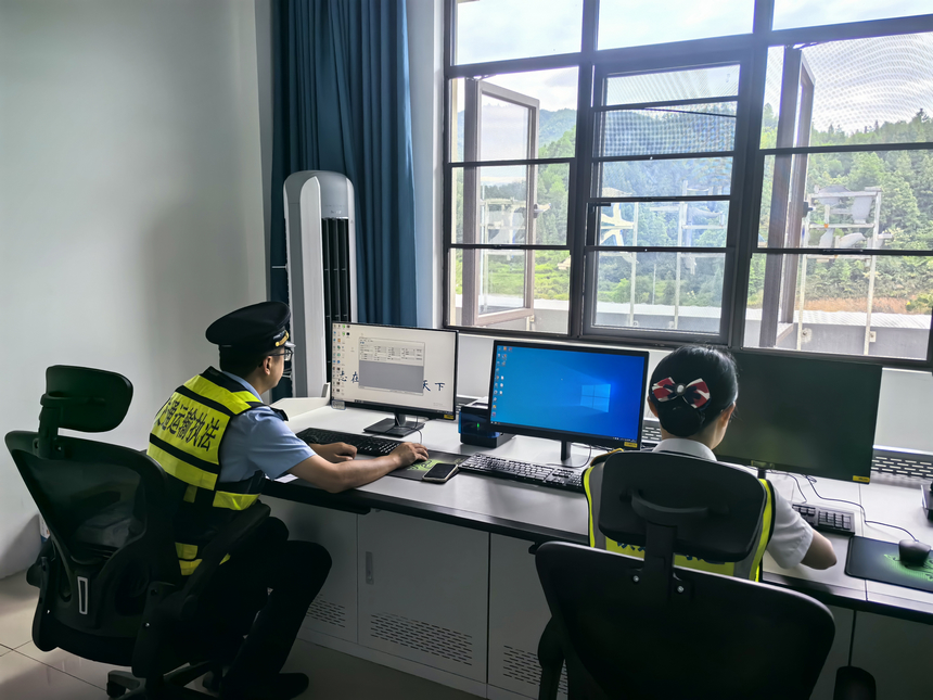 貴州省交通運輸綜合行政執法人員在收費站查看車輛數據進行排查。