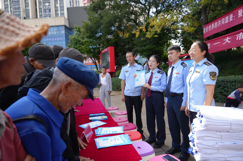 圖為稅務干部為參加活動的人員答疑解惑。李琪攝